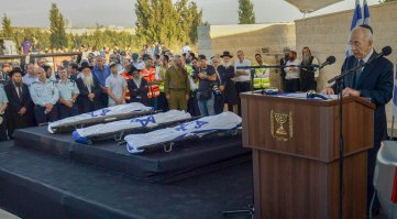 Gil-Ad Shaer, Naftali Frenkel and Eyal Yifrach are  laid to rest side-by-side in Modi'in cemetery on Tuesday evening, a day after their bodies were found in the West Bank and 19 days after they vanished while hitchihiking near Hebron. President Shimon Peres spoke at the funeral saying, "To all those who wish to vanquish us, I want to say that terror is a boomerang. It's targeted against us but hits its instigators. We bow our heads but won't lose our soul. I know that security forces will catch the murderers and they will be brought to justice."