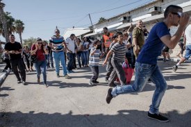 Israelis run for cover as a  rocket siren sounds in Ashkelon. More than 4,500 Hamas rockets were fired at Israel during the Gaza conflict.
