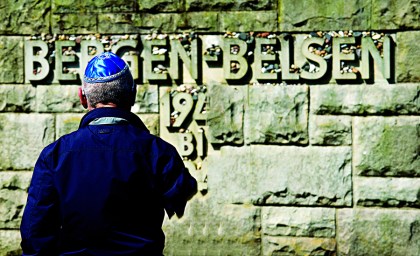 Holocaust survivor Ezra Davids standing at the Bergen-Belsen memorial.